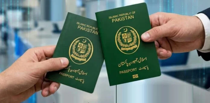 Two hands holding green Islamic Republic of Pakistan passports