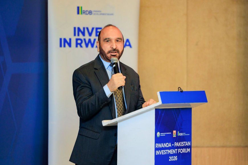 A speaker holding a microphone at a podium during the Rwanda-Pakistan Investment Forum 2026