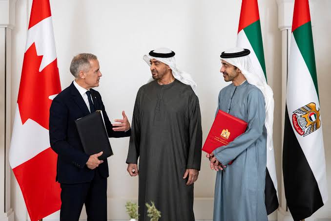 Mark Carney speaking with UAE President Sheikh Mohamed bin Zayed Al Nahyan in front of Canadian and UAE flags