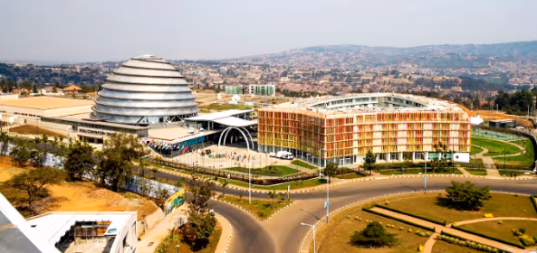 Aerial view of the Kigali Convention Centre featuring its iconic dome-shaped building and colorful adjacent hotel complex