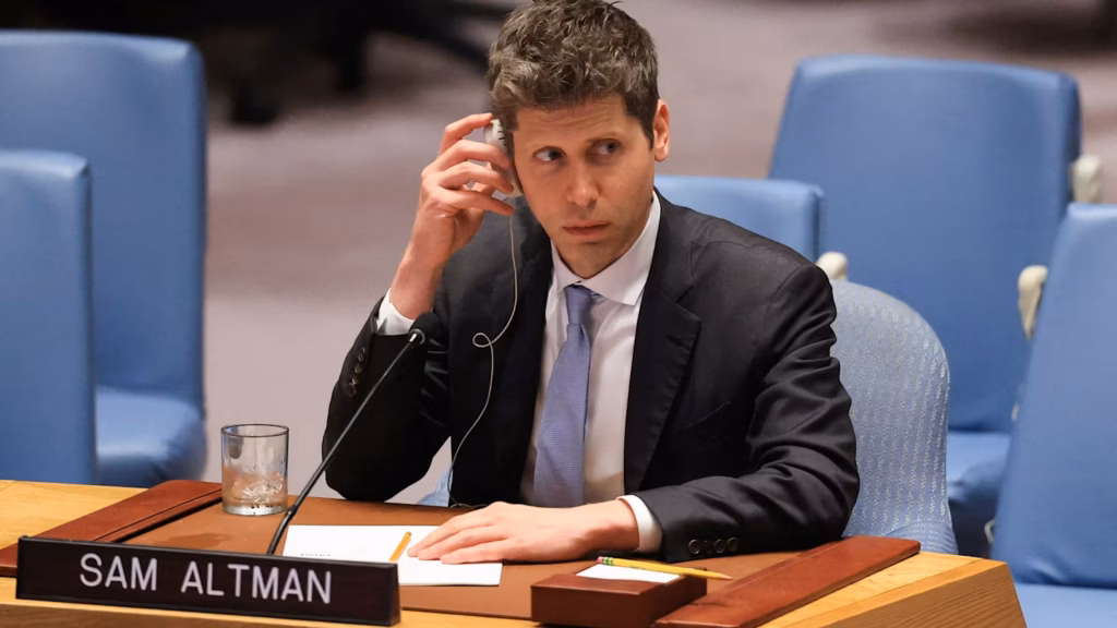 Sam Altman wearing a suit and holding a translation earpiece to his ear behind a desk with his nameplate