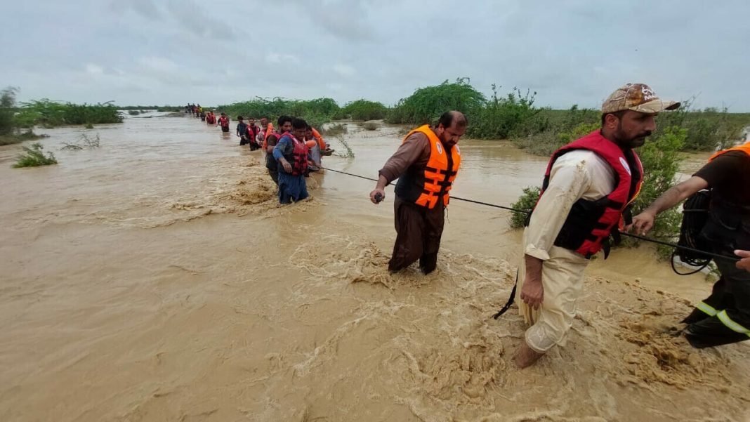 Islamic Relief Rescue workers help villagers evacuate in Lasbella, Balochistan.