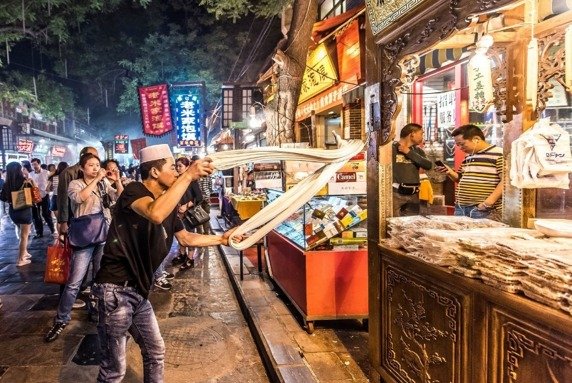 A Chef Making oil-splashed Noodles on the Historical Muslim Street