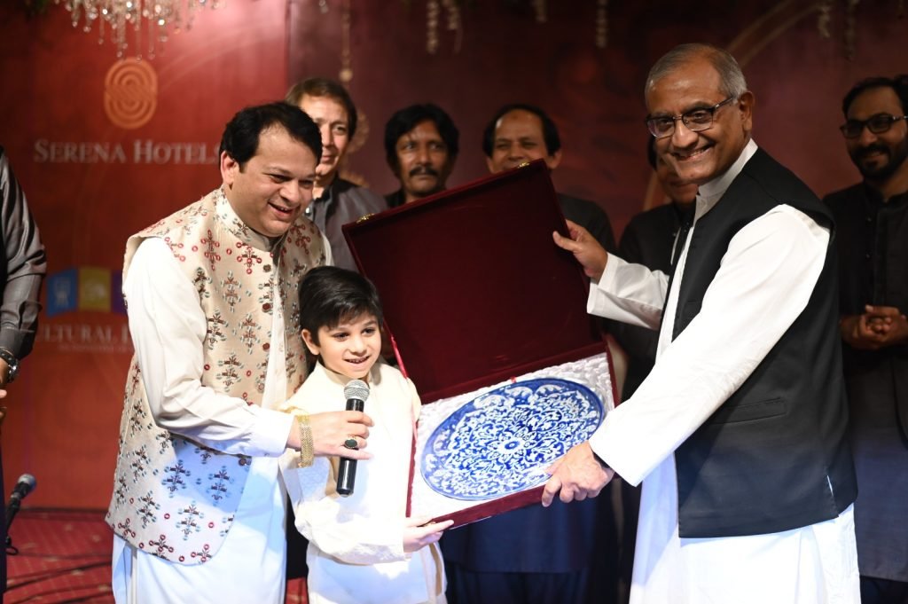 Ustad Santoo is presented with a souvenir.