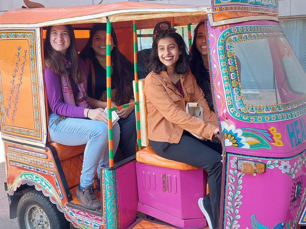 Visitors at Pakistan Embassy Washington pose in a rikshaw adorned with Pakistani Truck Art