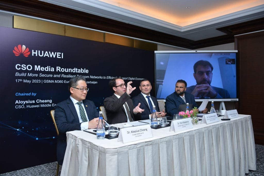 Huawei representatives at a cybersecurity roundtable discussing industry collaboration and digital protection.