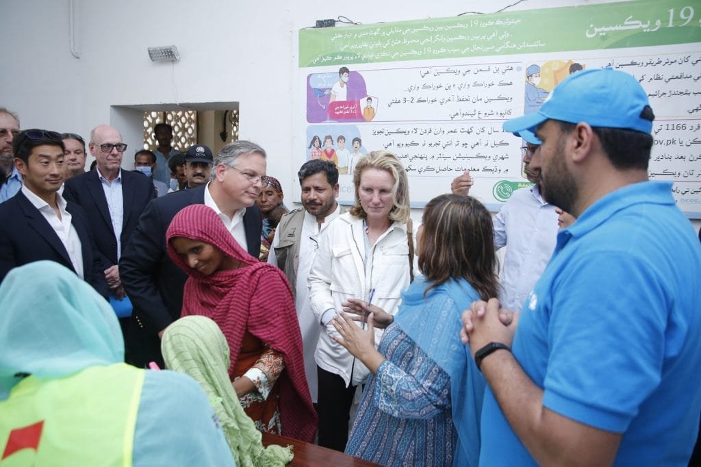 Flood-affected community rebuilding infrastructure with assistance from USAID funding.