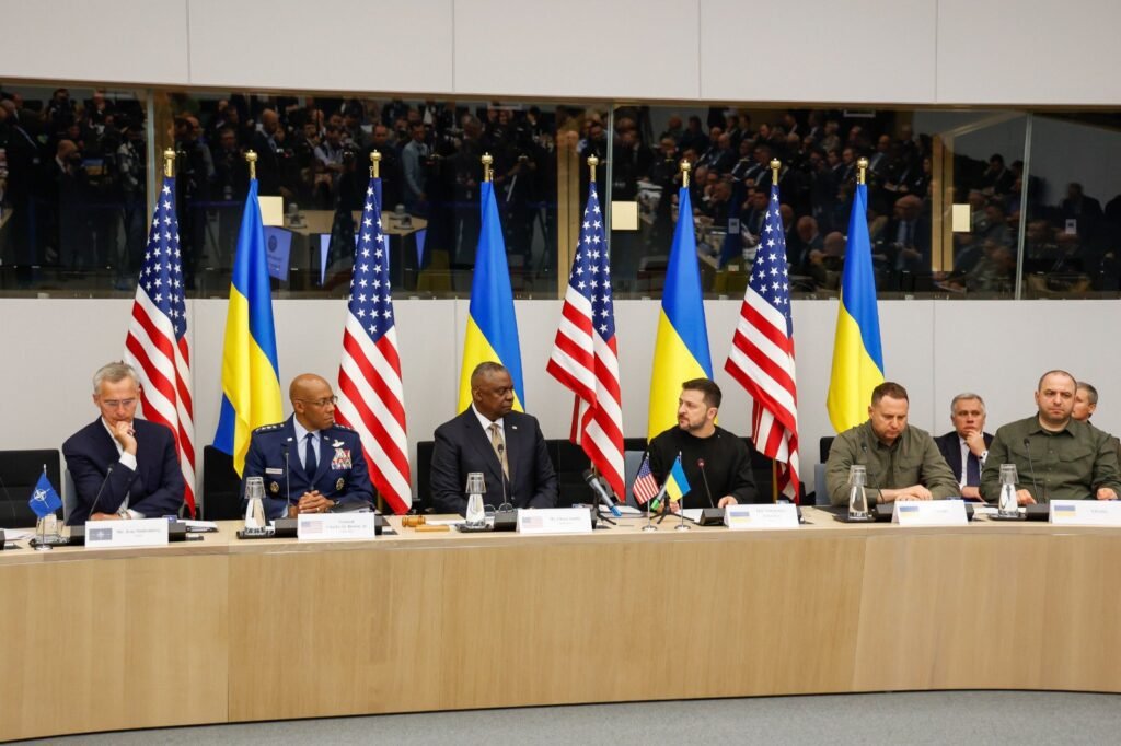 Ukraine Defense Contact Group meeting: President Zelensky speaks, flanked by international defense leaders. Details on financial aid and military support for Ukraine from US and European nations discussed.