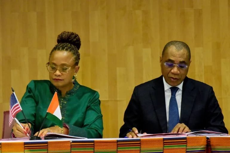 US Ambassador to the Ivory Coast Jessica Davis Ba, left, and Adam Coulibaly, minister of finance and budget, sign a health agreement in Abidjan, Ivory Coast, Tuesday, Dec. 30, 2025.