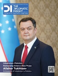 This image is the front cover of the April 2026 issue of The Diplomatic Insight magazine (Volume 19, Issue 04). The cover features a formal portrait of Alisher Tukhtaev, the Ambassador of Uzbekistan to Pakistan, standing centrally between the national flags of Uzbekistan (left) and Pakistan (right). He is wearing a dark navy suit with a bright red tie.