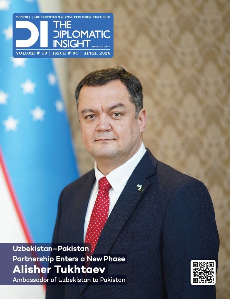 This image is the front cover of the April 2026 issue of The Diplomatic Insight magazine (Volume 19, Issue 04). The cover features a formal portrait of Alisher Tukhtaev, the Ambassador of Uzbekistan to Pakistan, standing centrally between the national flags of Uzbekistan (left) and Pakistan (right). He is wearing a dark navy suit with a bright red tie.